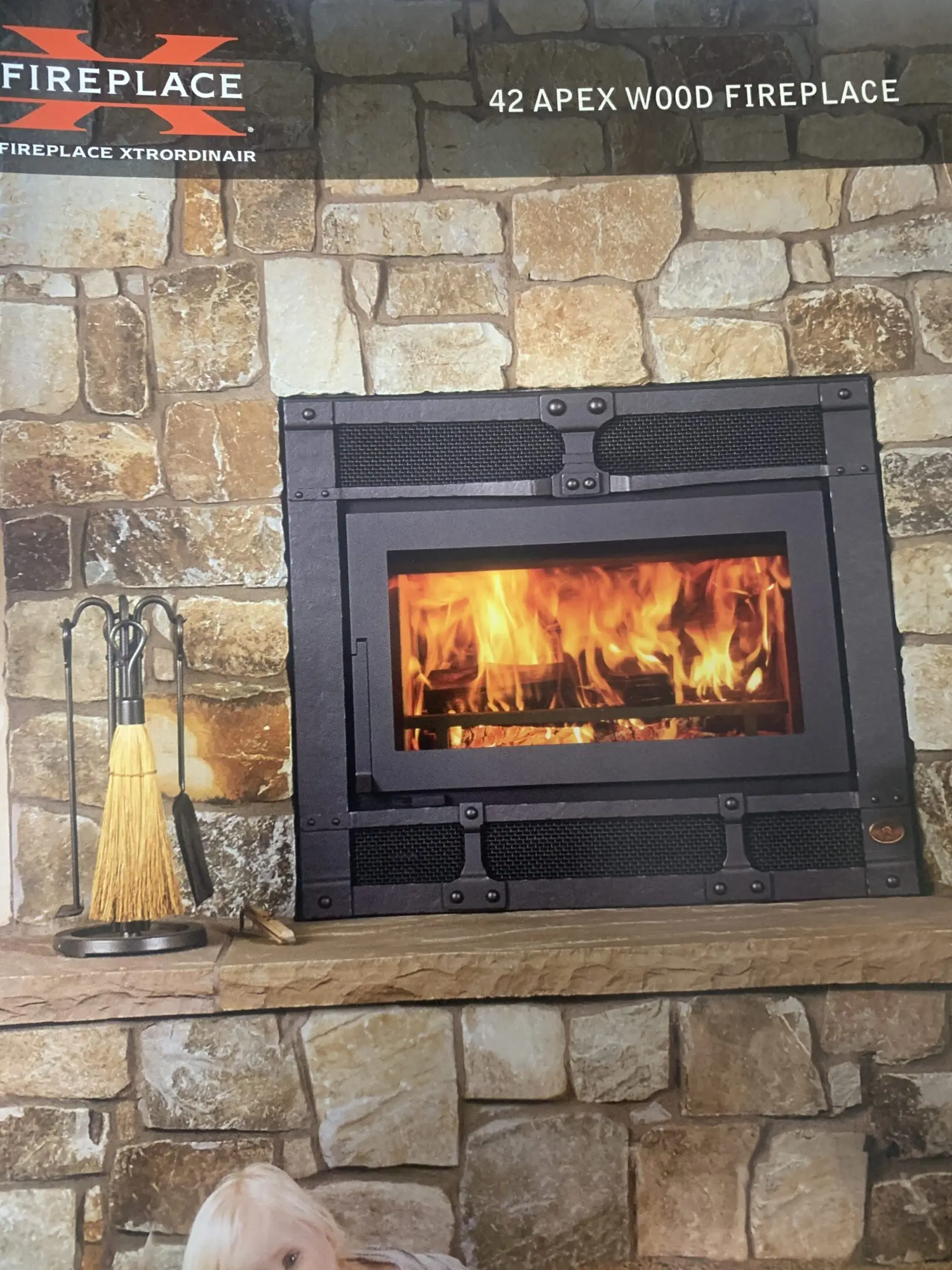 Stone fireplace with burning fire and tools