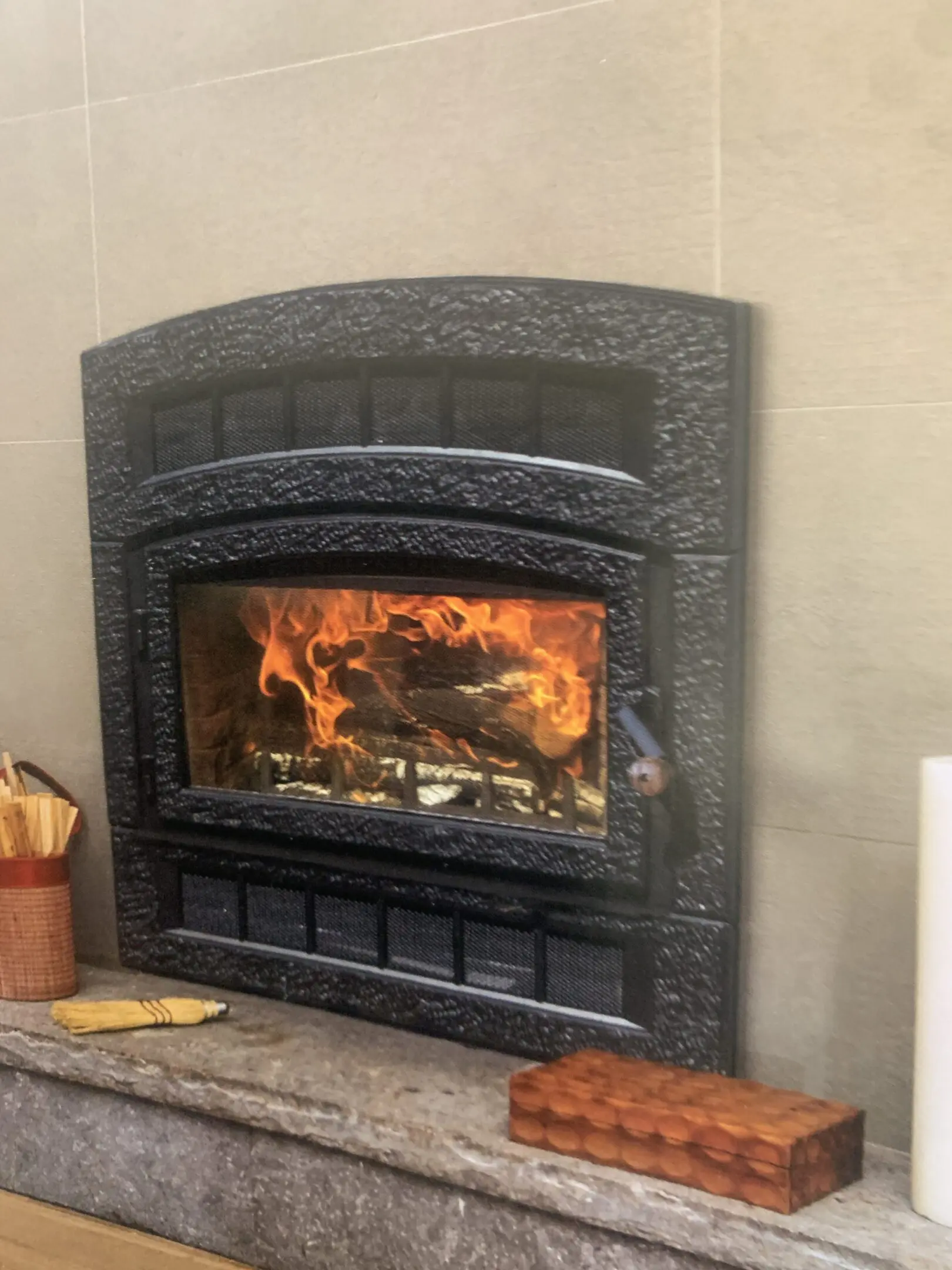 Cast-iron fireplace insert with roaring flames