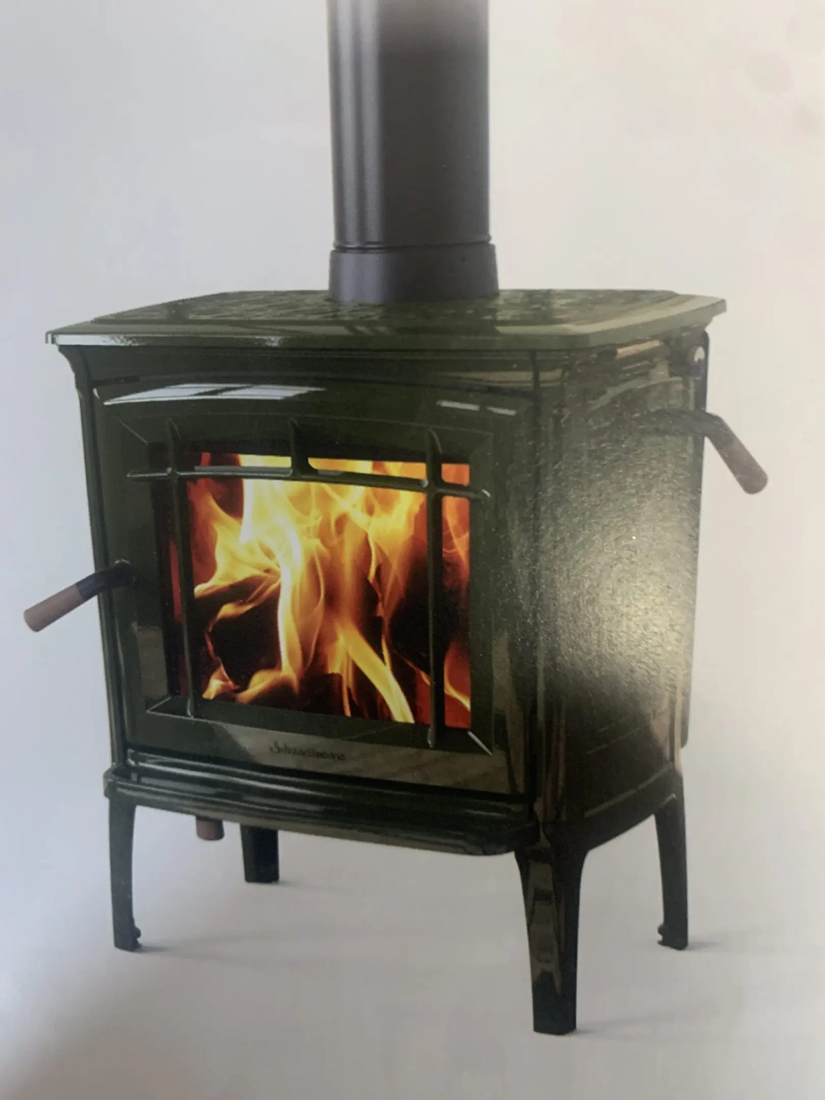 Cast-iron wood stove with visible flame