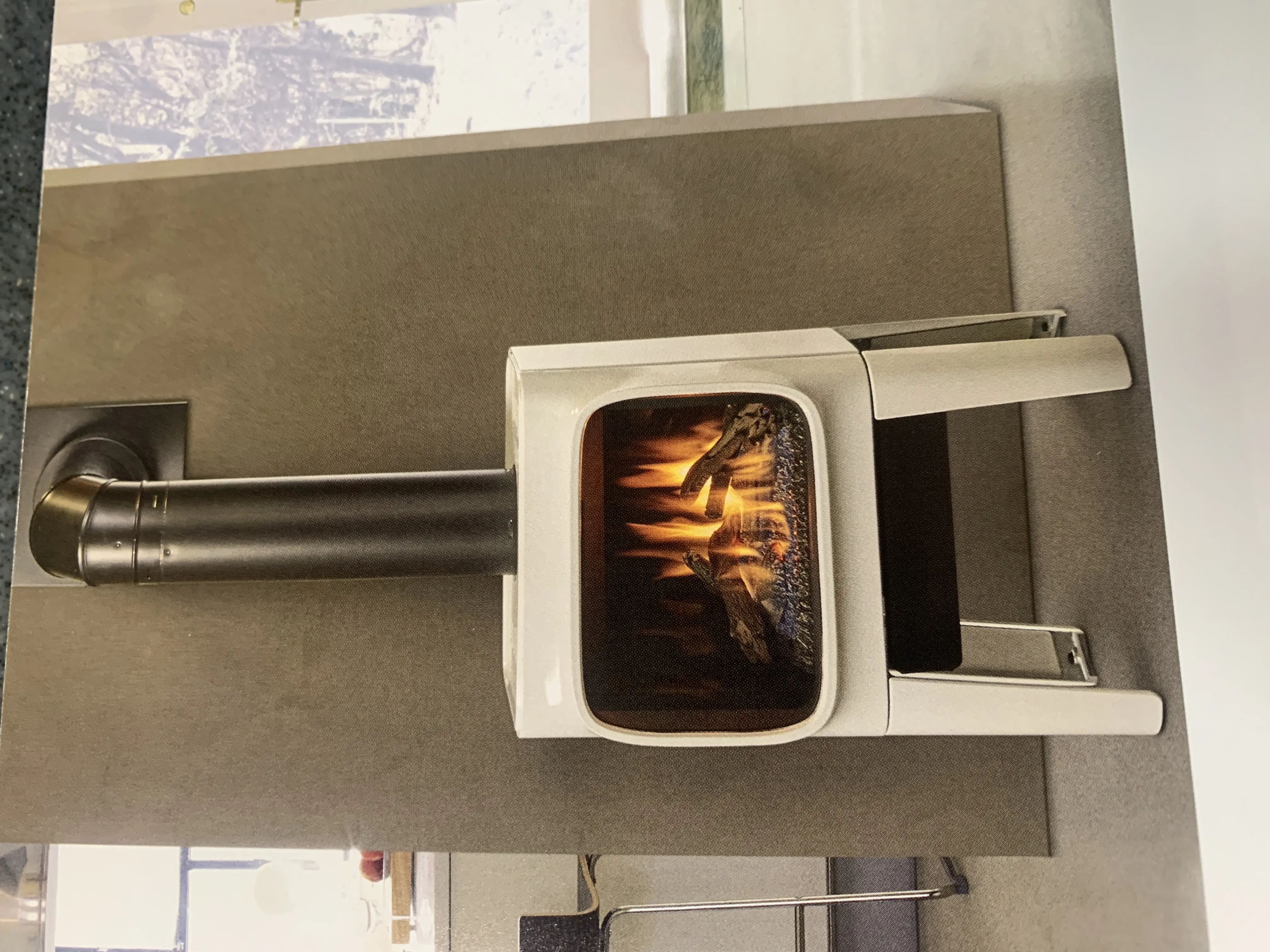 Modern white freestanding wood stove with fire