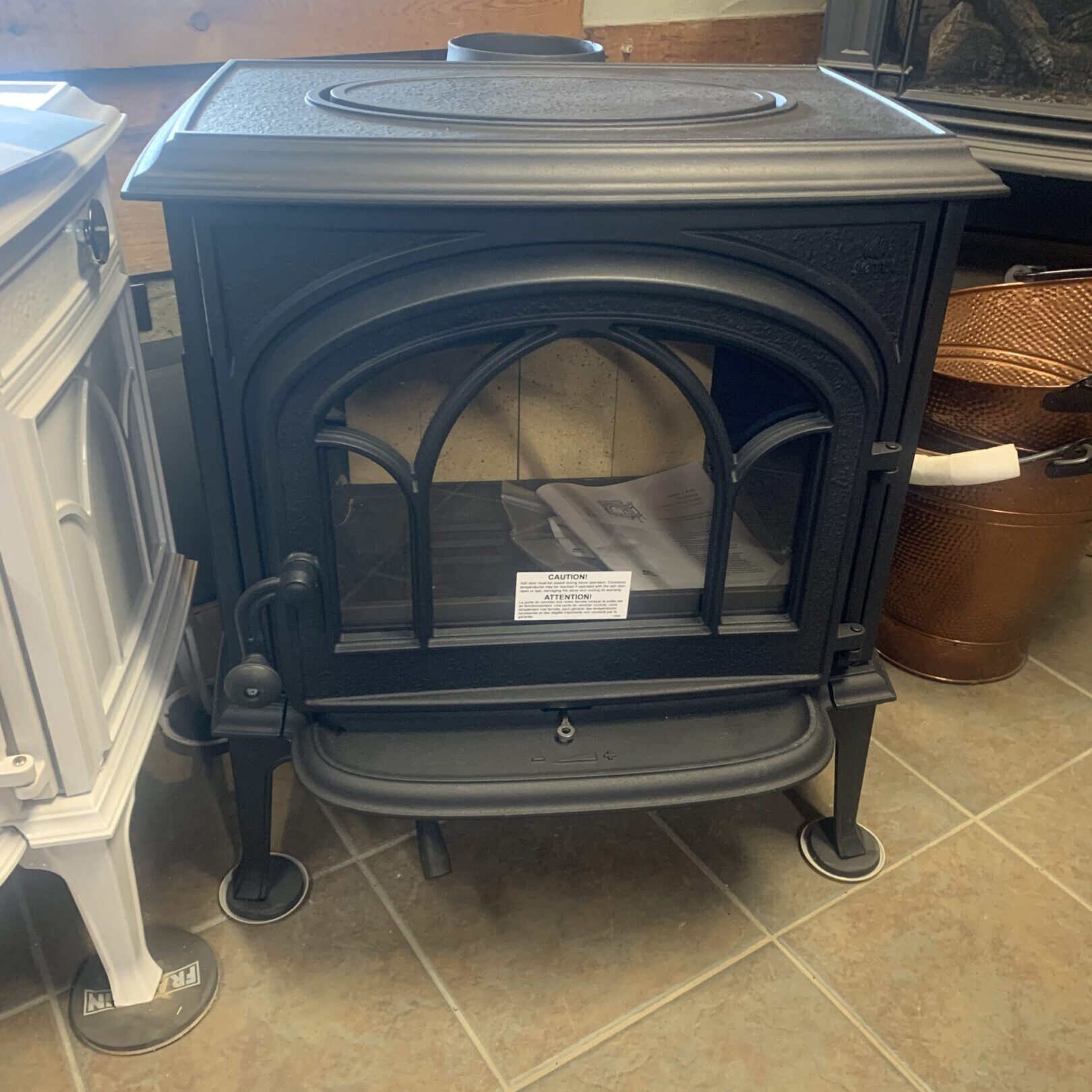 Black cast-iron wood-burning stove with glass door